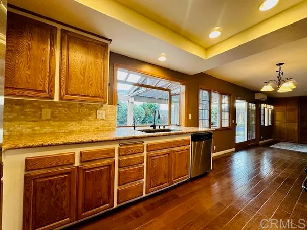 a large kitchen with wooden floors and a sink