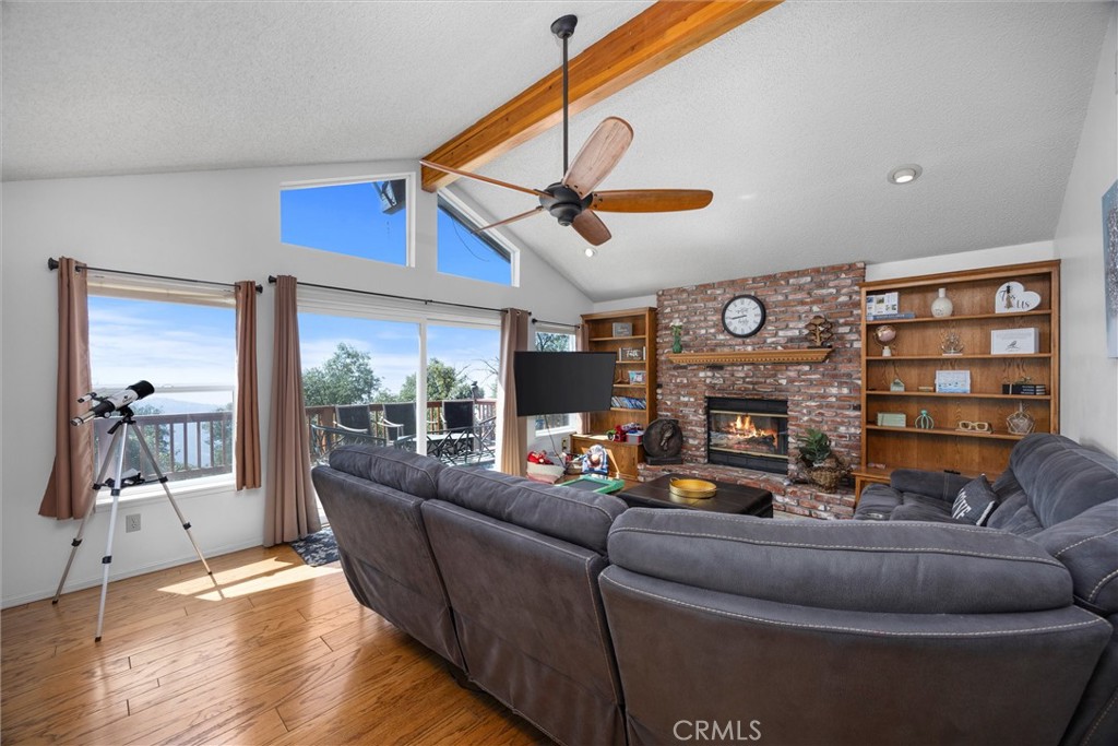 26511 Teal Court Tehachapi, CA 93561 - Photo 13 of 68 a living room with furniture a fireplace and a large window