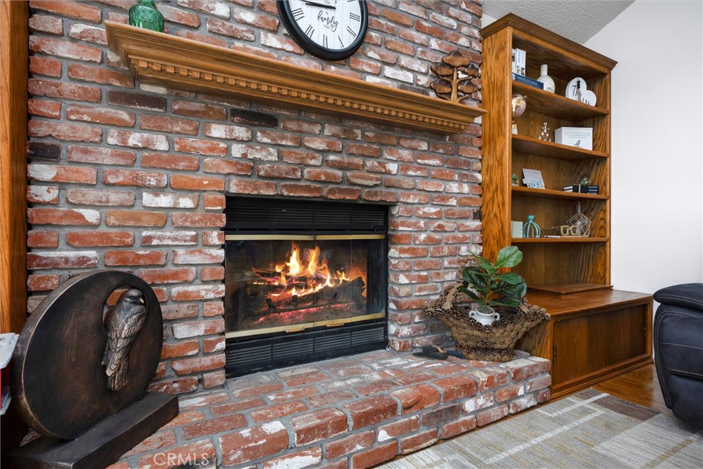 26511 Teal Court Tehachapi, CA 93561 - Photo 15 of 68 a living room with a fireplace a rug and a fireplace