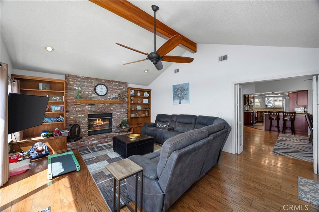 26511 Teal Court Tehachapi, CA 93561 - Photo 16 of 68 a living room with furniture a flat screen tv and a fireplace