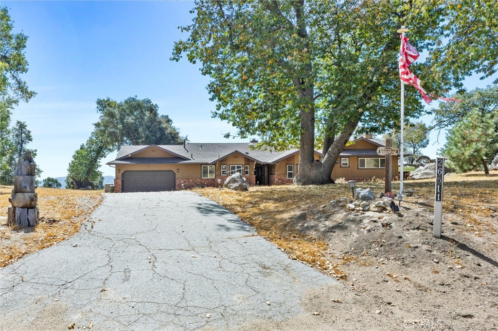 26511 Teal Court Tehachapi, CA 93561 - Photo 2 of 68 a front view of a house with a yard and trees