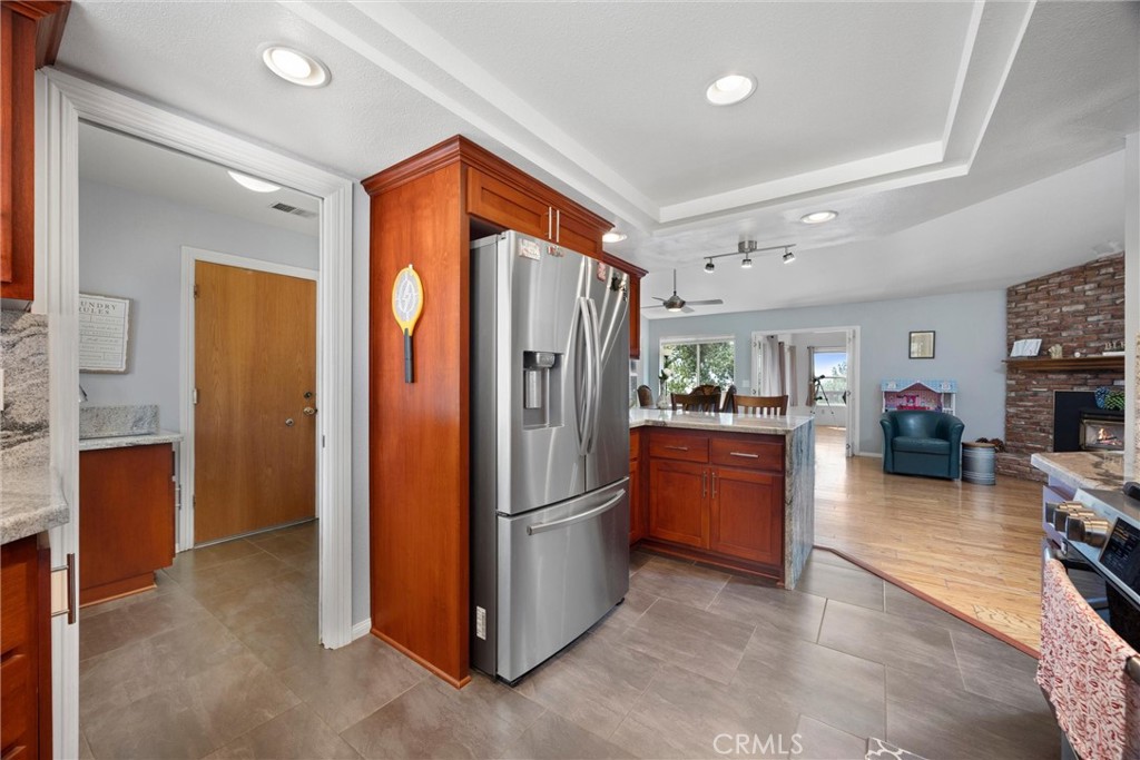 26511 Teal Court Tehachapi, CA 93561 - Photo 24 of 68 a kitchen with refrigerator and cabinets