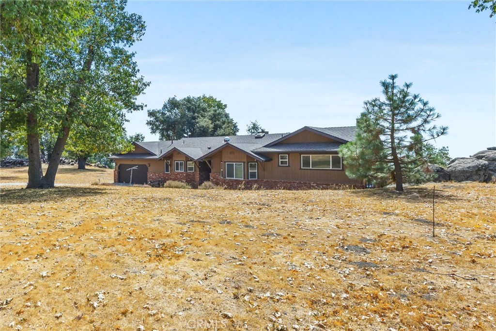 26511 Teal Court Tehachapi, CA 93561 - Photo 4 of 68 a front view of a house with a yard and garage