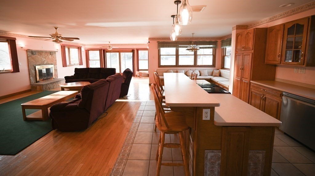 141 Ashby Road Ashburnham, MA 01430 - Photo 7 of 30 a living room with couches a dining table and chairs with wooden floor
