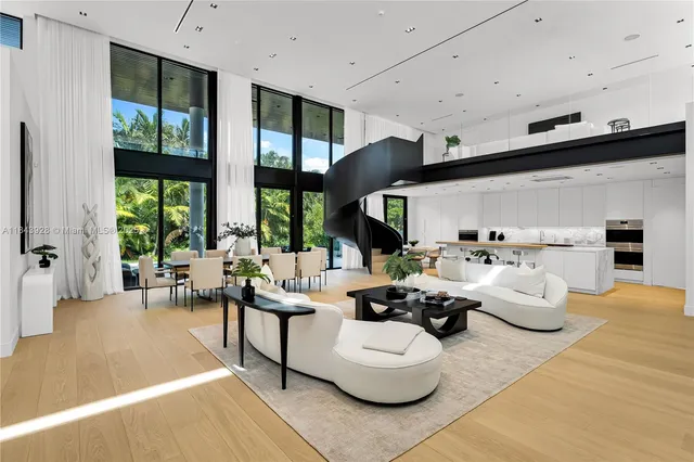 a living room with furniture fireplace and large windows