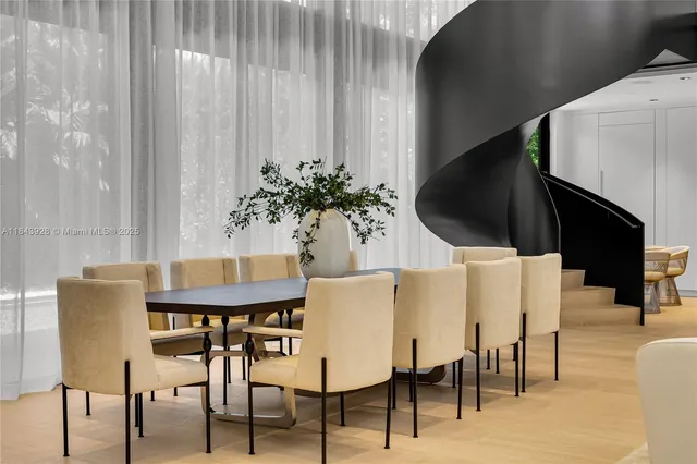 a view of a dining room with furniture and a potted plant