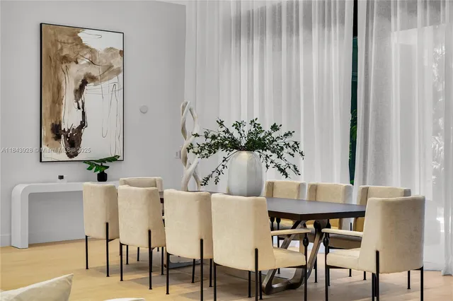 a view of a dining room with furniture large windows and wooden floor