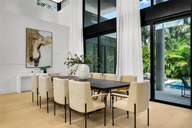 a living room with furniture a wall paintings and a fireplace