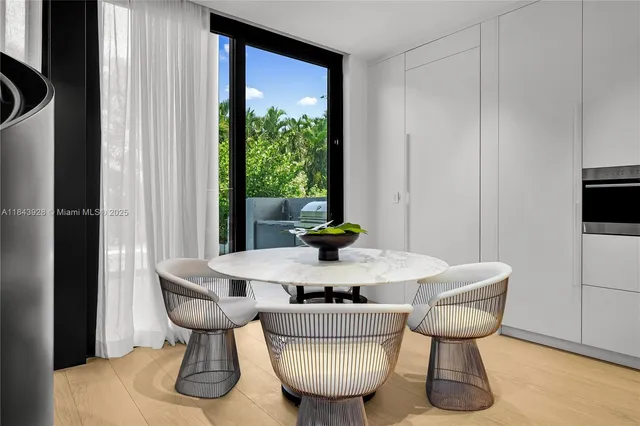 a living room with furniture potted plant and a large window