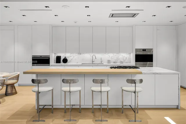 a living room with furniture and large windows