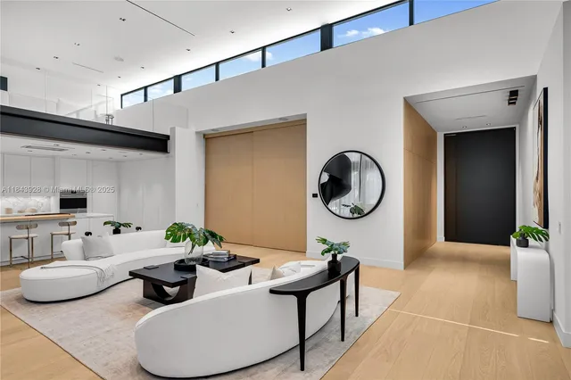 a living room with furniture and a mirror