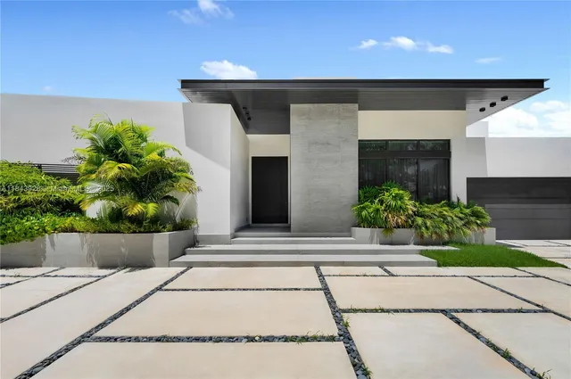 an aerial view of a house with garden space and a swimming pool