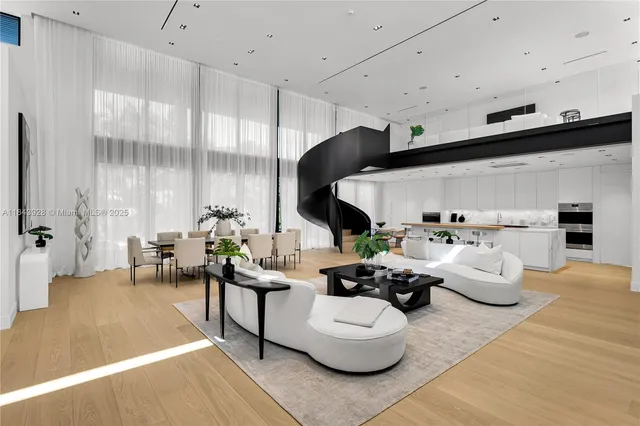 a living room with furniture kitchen view and a large window