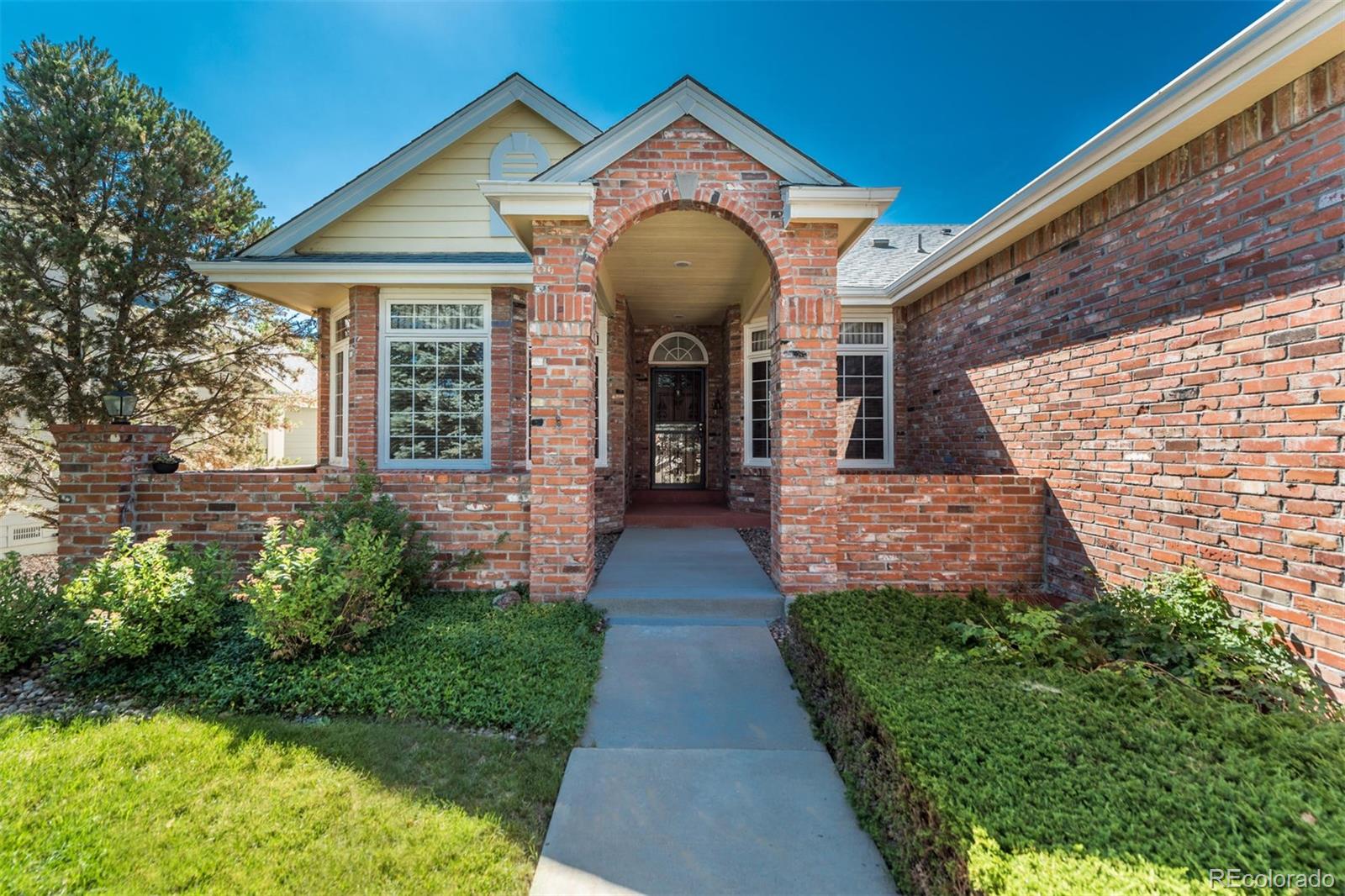 a front view of a house with garden
