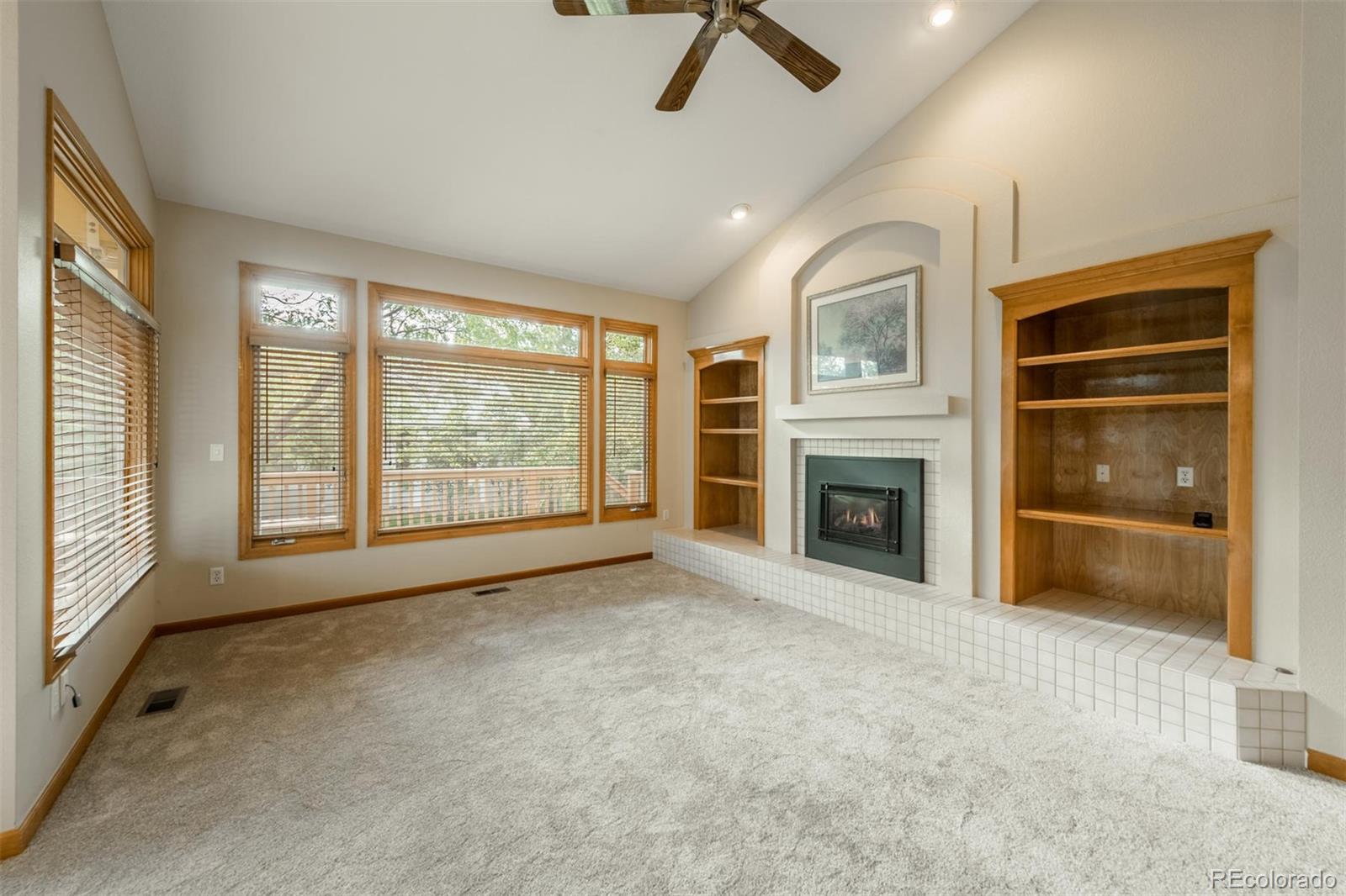 14 Hathaway Lane Highlands Ranch, CO 80130 - Photo 13 of 29 a view of an empty room with a fireplace and a window