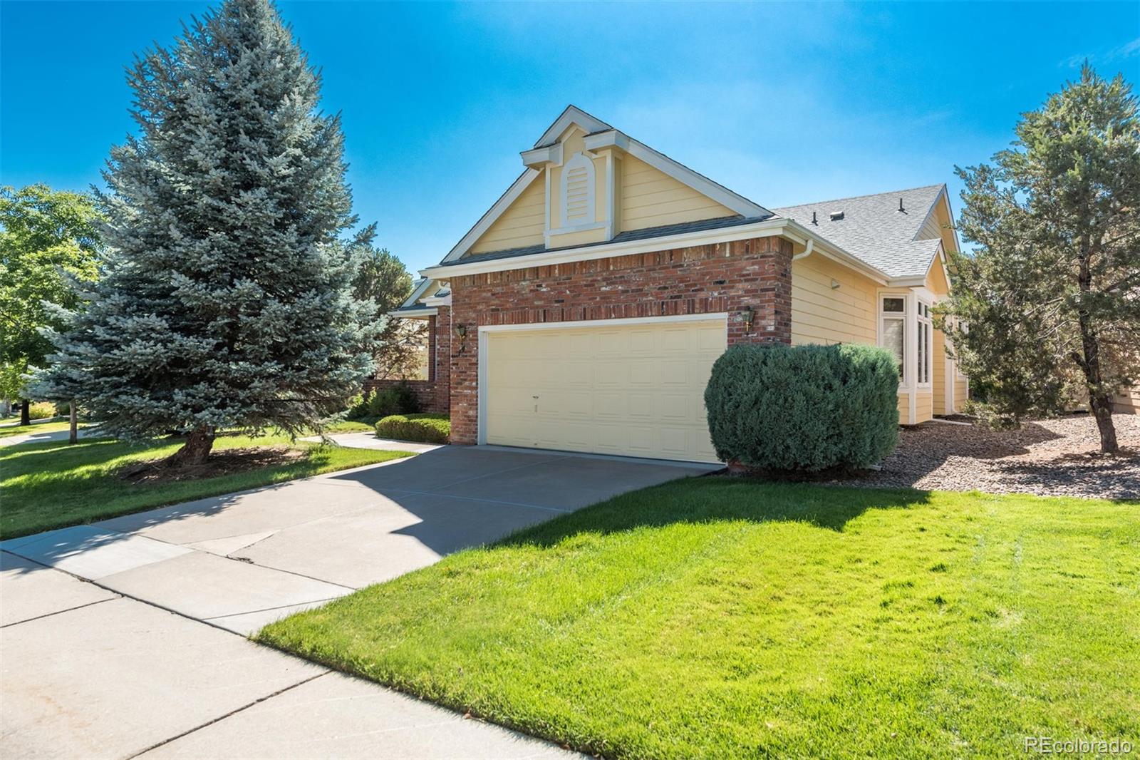 14 Hathaway Lane Highlands Ranch, CO 80130 - Photo 3 of 29 a front view of a house with a yard and garage