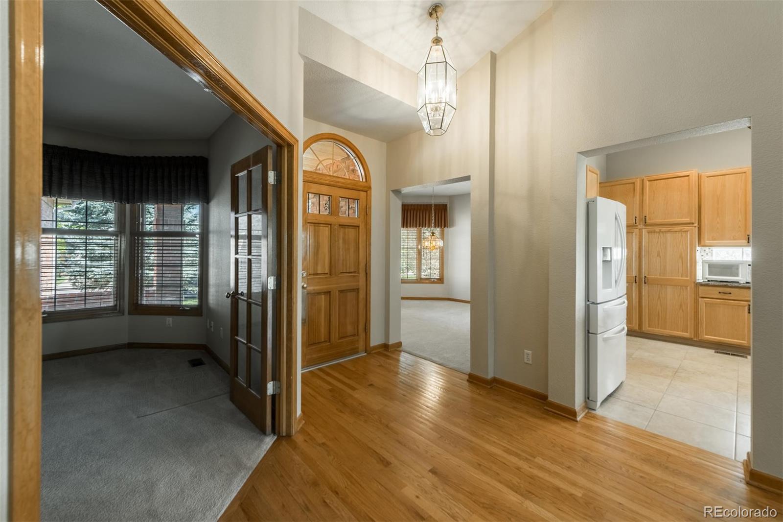 14 Hathaway Lane Highlands Ranch, CO 80130 - Photo 4 of 29 a view of a hallway with wooden shelves