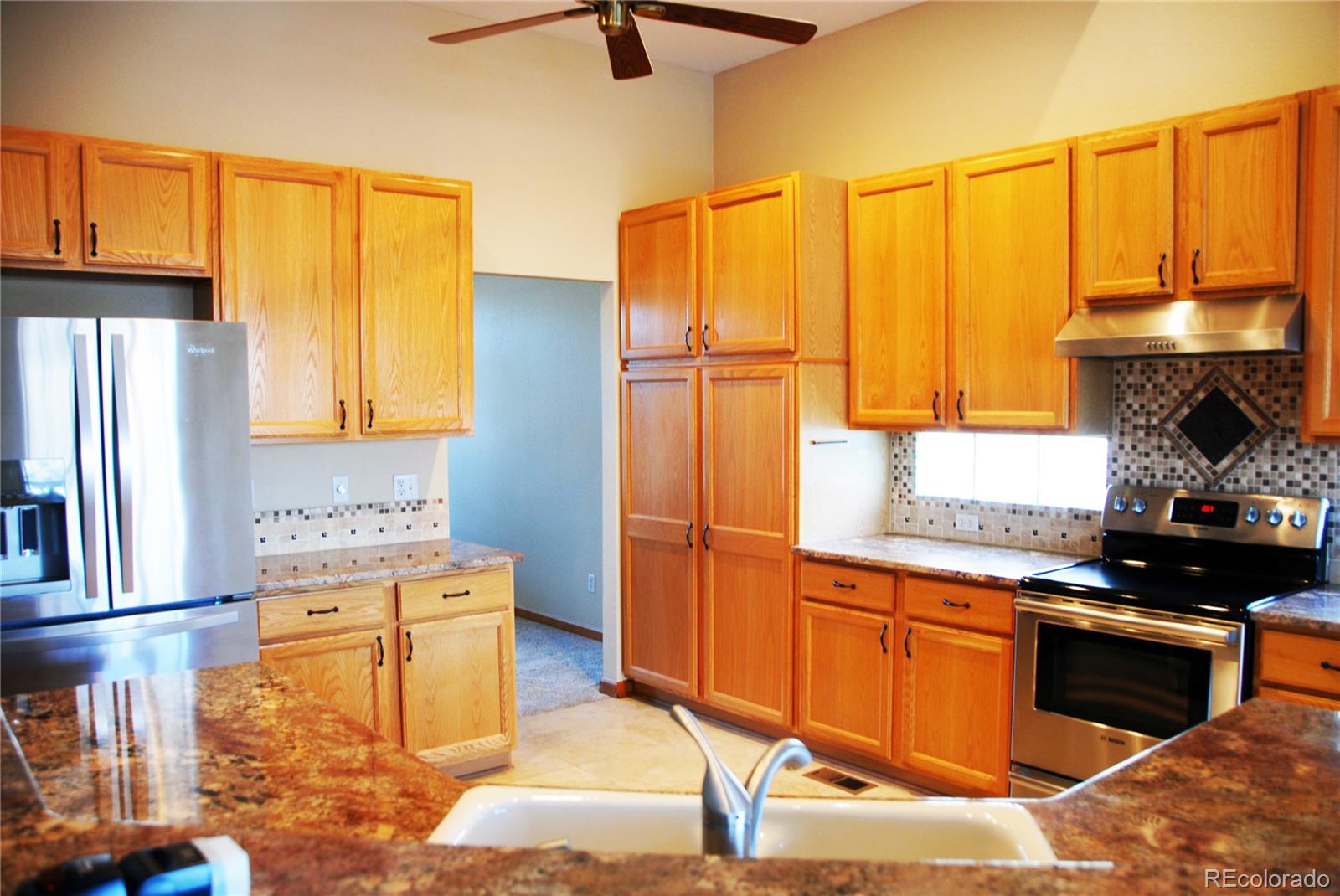 14 Hathaway Lane Highlands Ranch, CO 80130 - Photo 9 of 29 a kitchen with stainless steel appliances granite countertop a stove a sink and a refrigerator