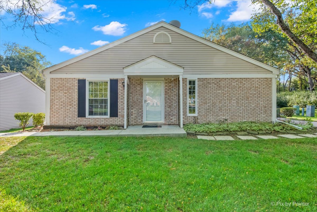20 Red Oak Trail Cary, IL 60013 - Photo 1 of 27 a front view of a house with a garden and yard