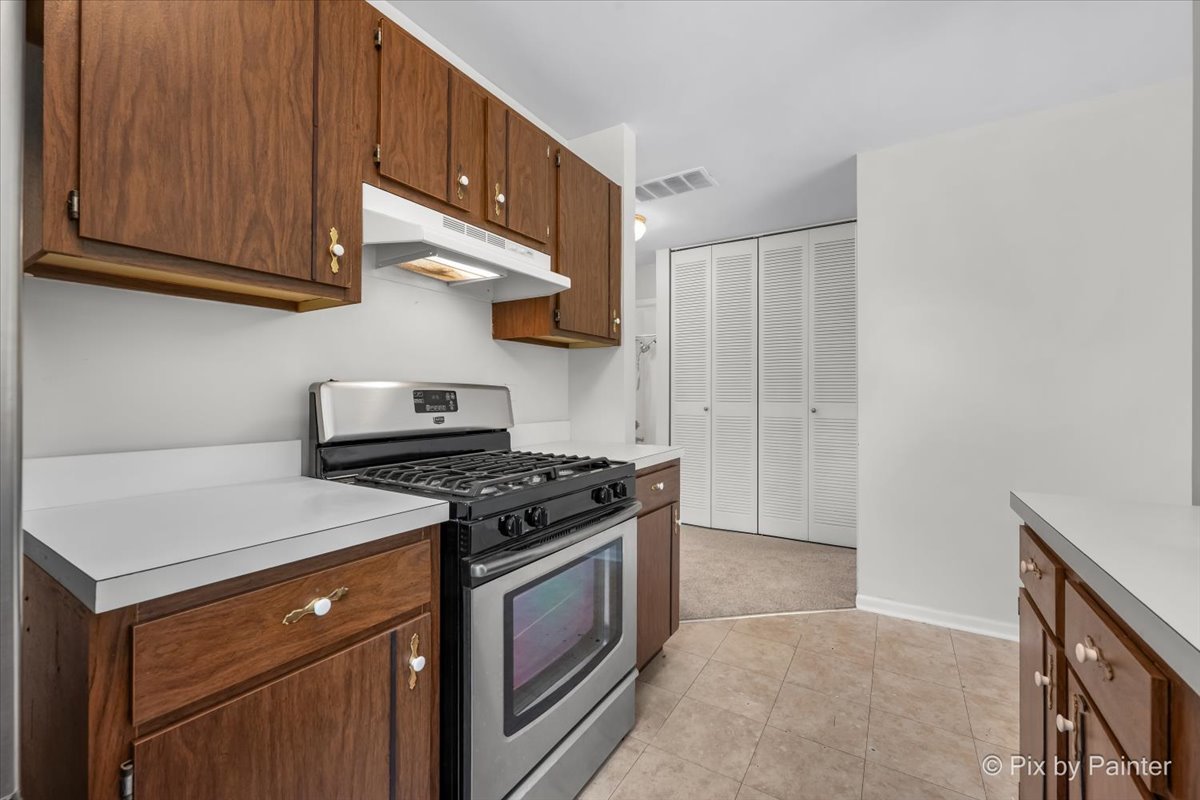 20 Red Oak Trail Cary, IL 60013 - Photo 11 of 27 a kitchen with stainless steel appliances granite countertop a stove and a microwave