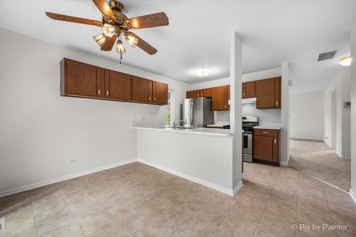 20 Red Oak Trail Cary, IL 60013 - Photo 13 of 27 a kitchen with stainless steel appliances a refrigerator and a microwave