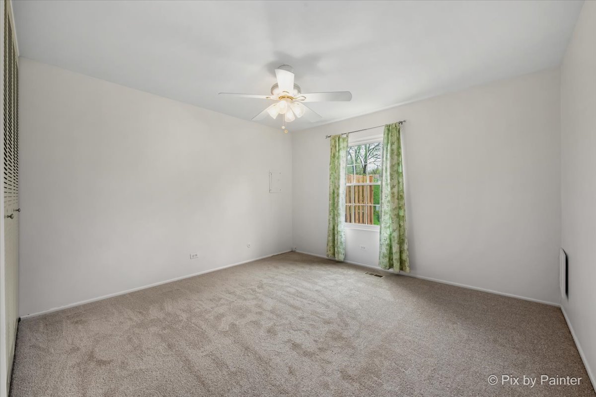 20 Red Oak Trail Cary, IL 60013 - Photo 15 of 27 an empty room with a window and a fan