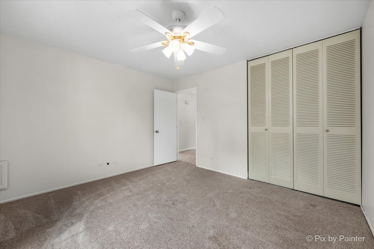 20 Red Oak Trail Cary, IL 60013 - Photo 16 of 27 an empty room with a chandelier fan and windows