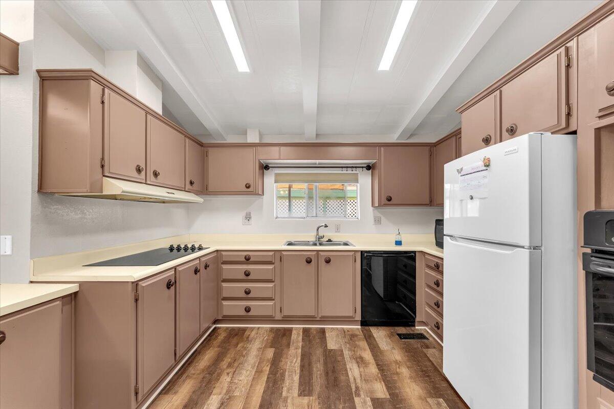 350 Gilmore Road, Unit SPC 16 Red Bluff, CA 96080 - Photo 14 of 35 a kitchen with a sink a refrigerator and cabinets