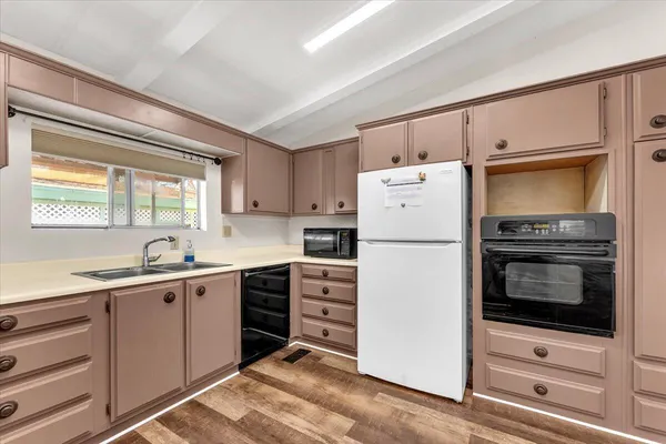 a kitchen with a refrigerator stove and sink