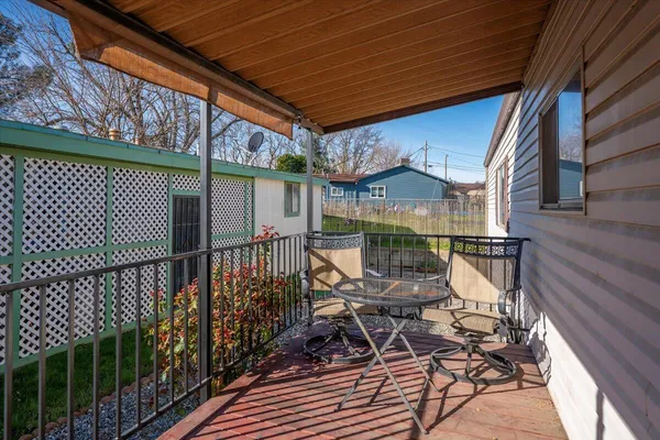 a view of balcony with wooden floor and outdoor seating