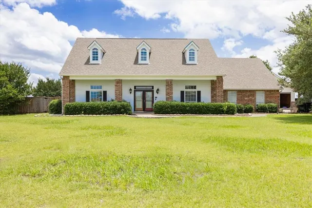 a front view of house with yard and green space