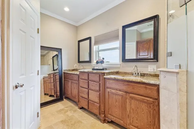 a bathroom with a granite countertop sink vanity and mirror
