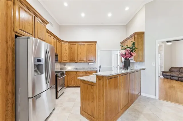 a kitchen with stainless steel appliances granite countertop a refrigerator and a sink