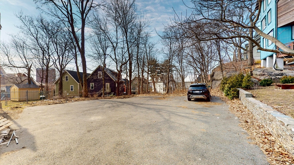181 Highland Street, Unit 1 Boston, MA 02119 - Photo 11 of 11 a view of a house with a snow in the road