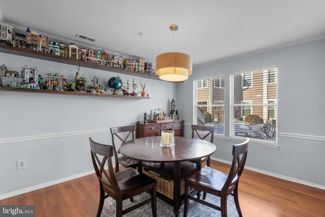 a view of a dining room that has a table and chairs in it