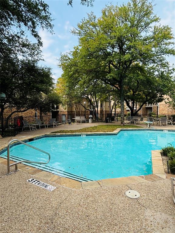 14277 Preston Road, Unit 416 Dallas, TX 75254 - Photo 11 of 40 Inviting swimming pool with integrated steps and a stainless steel handrail, surrounded by a textured aggregate deck