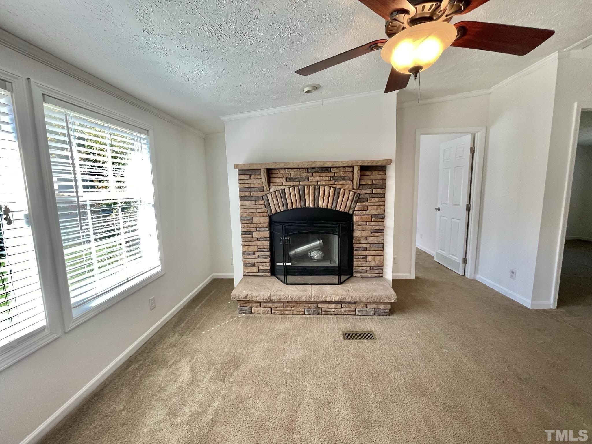 45 Divine Lane Roxboro, NC 27573 - Photo 11 of 28 a view of an empty room with a fireplace and a window