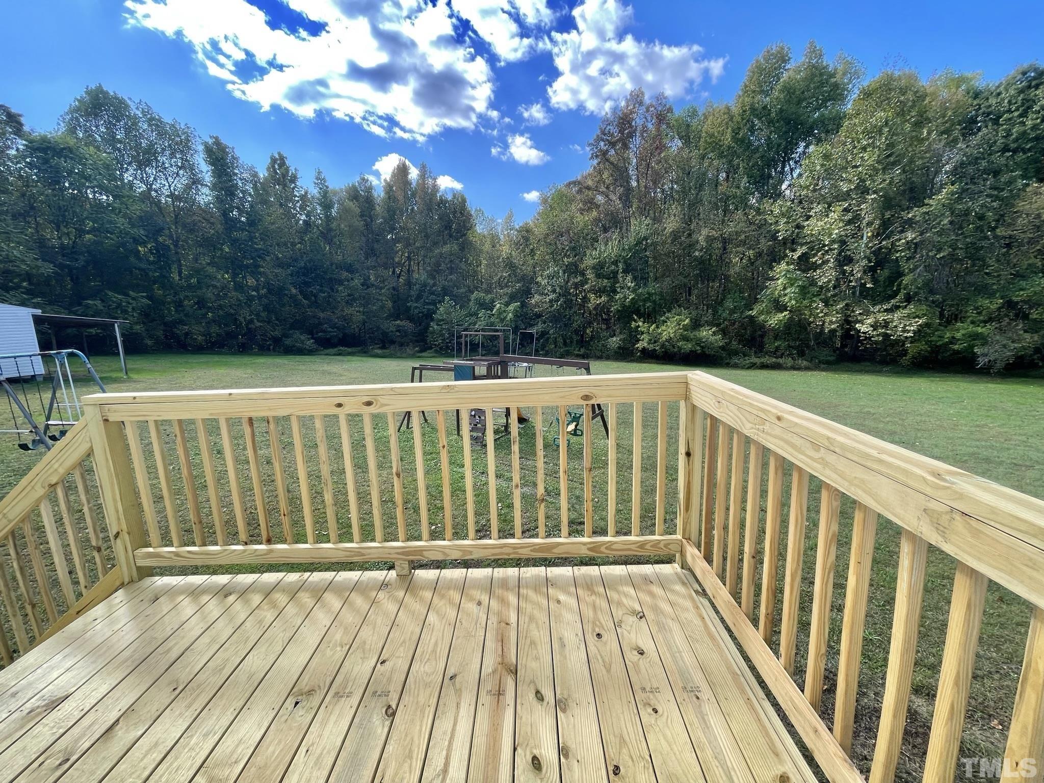 45 Divine Lane Roxboro, NC 27573 - Photo 23 of 28 a view of balcony with wooden floor and trees