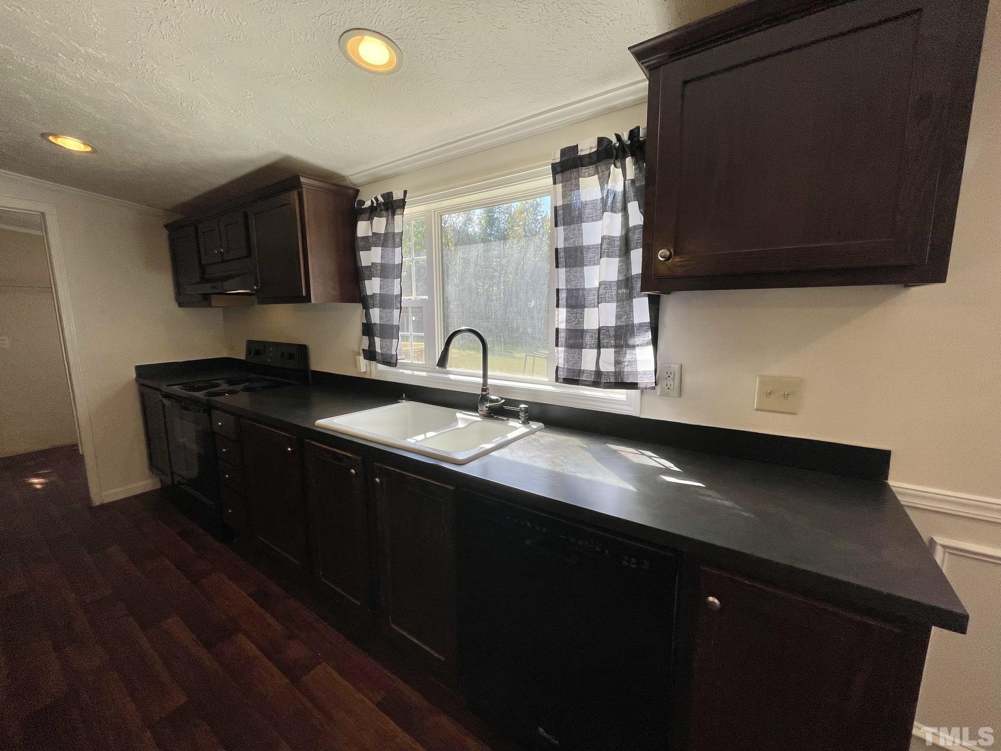 45 Divine Lane Roxboro, NC 27573 - Photo 8 of 28 a kitchen with a sink and a microwave