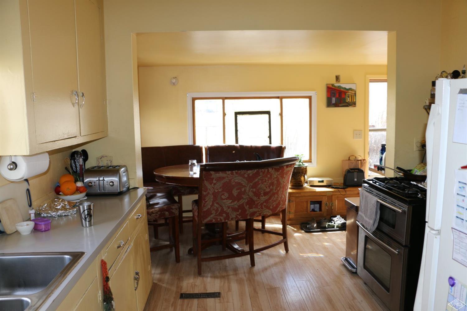 1500 Sylvan Lake Road Eagle, CO 81631 - Photo 8 of 10 a view of a dining room with furniture and wooden floor