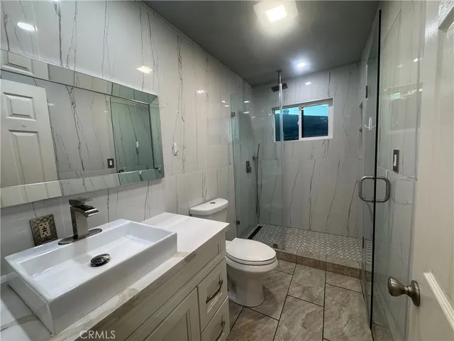a bathroom with a sink toilet and mirror