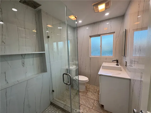 a bathroom with a shower sink and toilet