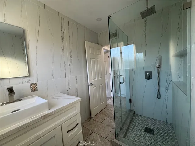 a bathroom with a sink vanity and mirror