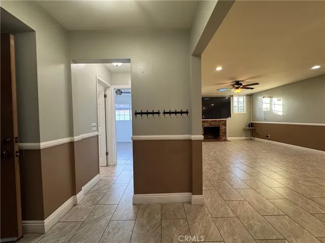 a view of a hallway with wooden walls