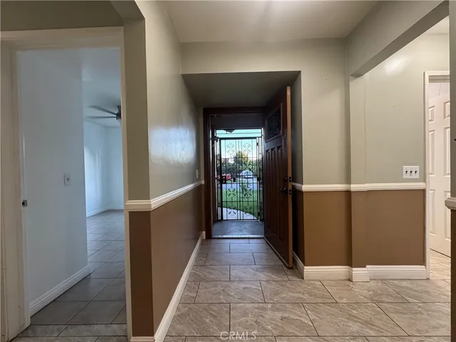 a view of a livingroom with a ceiling fan and window