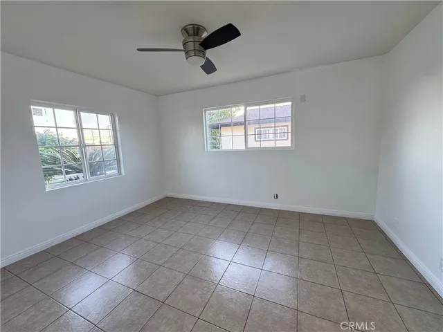 a view of a livingroom with a ceiling fan and window