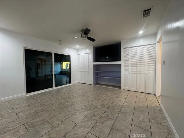 a view of a hallway with a livingroom with furniture