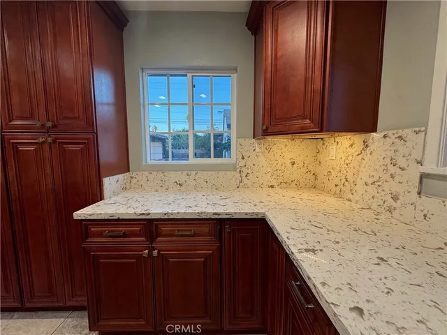 a kitchen with stainless steel appliances granite countertop wooden cabinets a stove top oven a sink and dishwasher