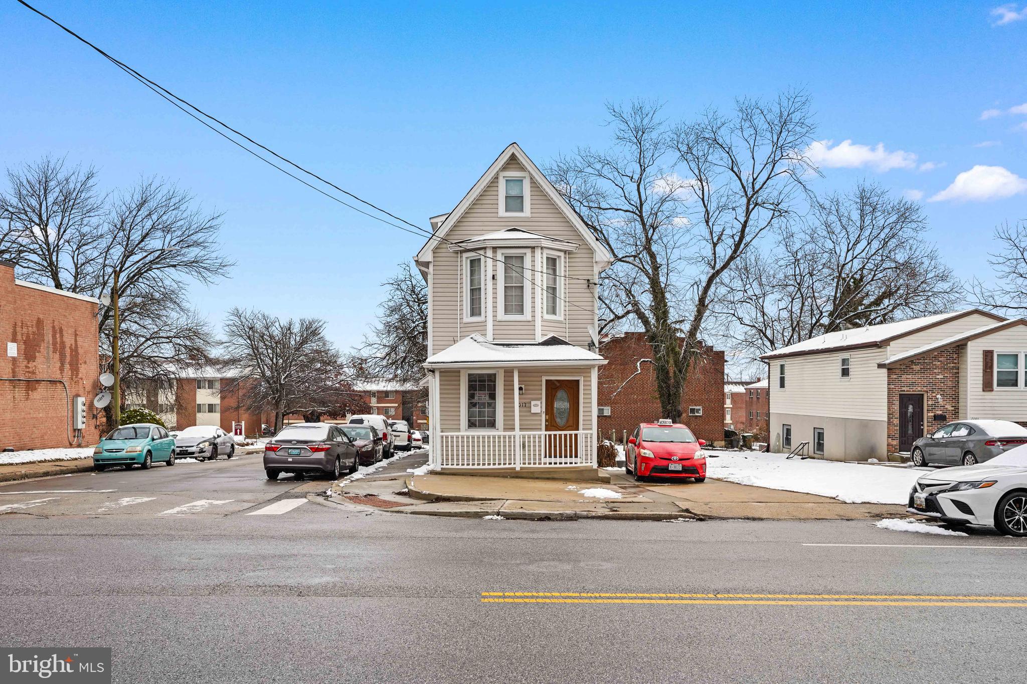 5013 The Alameda Baltimore, MD 21239 - Photo 1 of 24 a front view of a building with cars parked