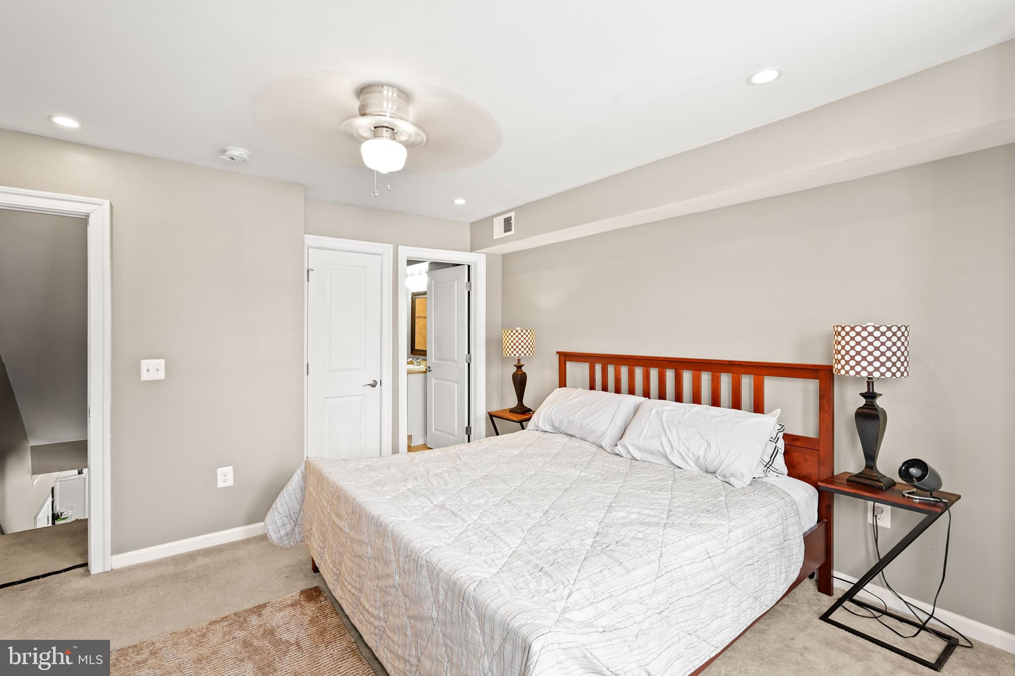 5013 The Alameda Baltimore, MD 21239 - Photo 12 of 24 a large white bed in a white room